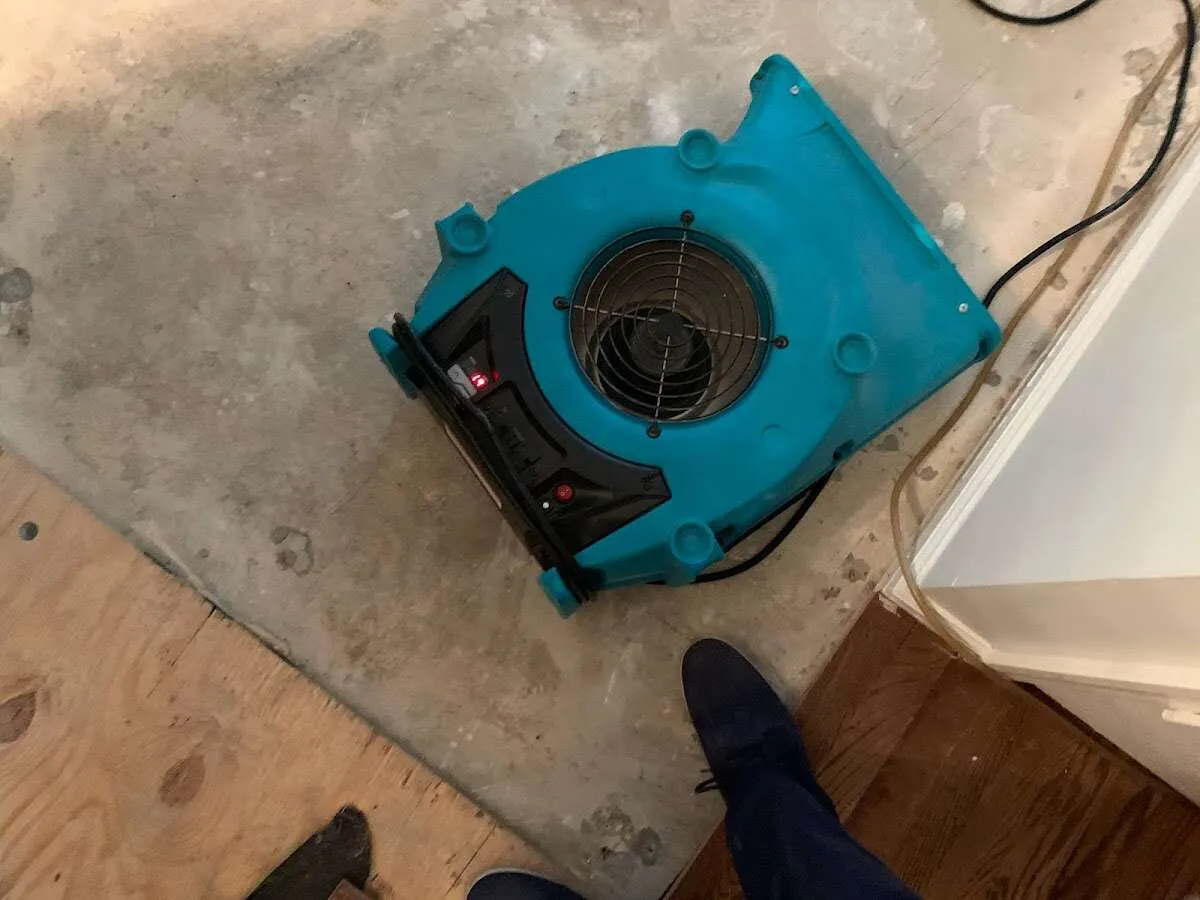 Air mover drying subfloor during Commercial Water Damage Restoration in Salinas